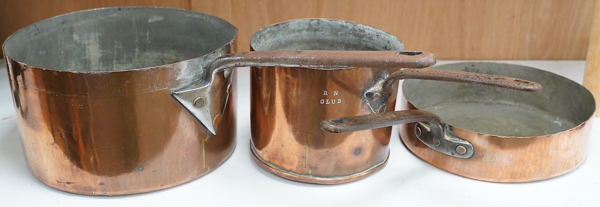 Three copper pans, one stamped RN Club, largest 63cm. Condition - fair